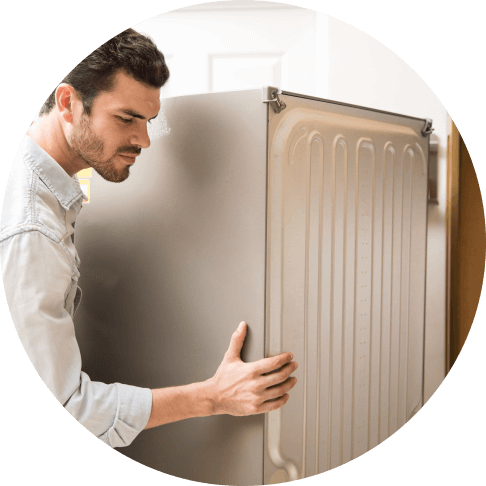 Appliance repair in Orange County – technician checking behind refrigerator