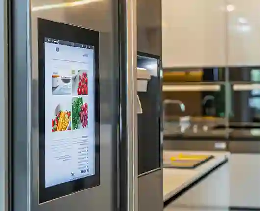 Appliance repair services in Orange County – refrigerator with large screen in modern kitchen