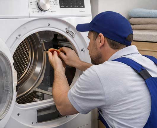 Technician performing dryer repair Orange County in a residential laundry area