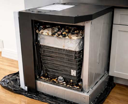 Broken trash compactor unit showing mechanical failure, trash compactor repair near me concept