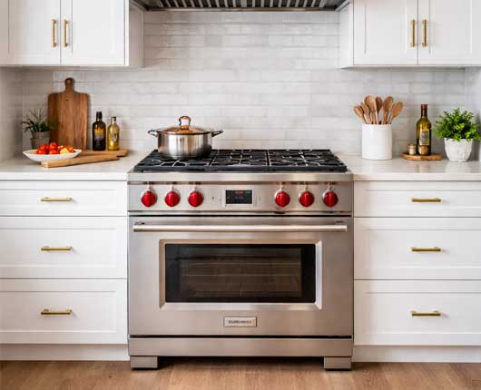 Stainless steel kitchen range in contemporary home interior → appliance repair near me